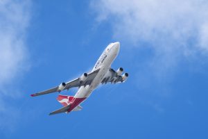 Qantas Boeing 747-438(ER) VH-OEF as flight QF15 climbing out from YBBN en route to KLAX. Condensation trails are visible on the wing trailing edges and wingtips.