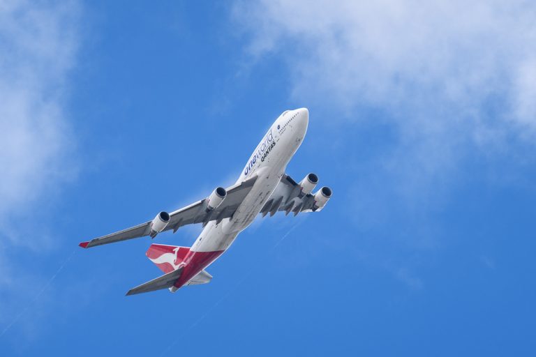 Qantas Boeing 747-438(ER) VH-OEF as flight QF15 climbing out from YBBN en route to KLAX. Condensation trails are visible on the wing trailing edges and wingtips.