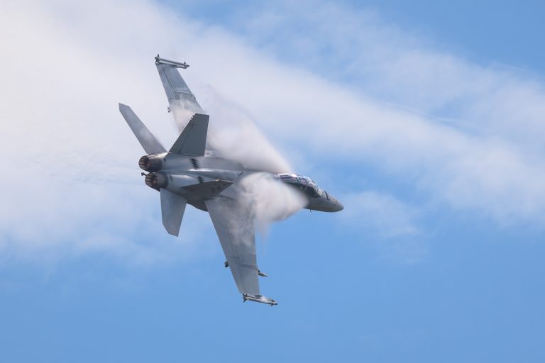 Boeing F/A-18F Super Hornet A44-221 of 1SQN RAAF performing its flying display at TAVAS GWFD 2018. Condensation sheets are forming on wing leading edges.