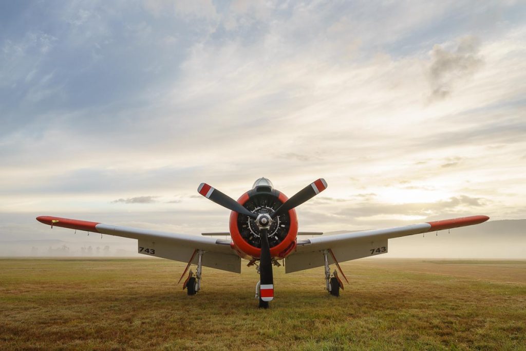 North American T-28B Trojan VH-RPX "Miss Stress" in a foggy sunrise at Red Thunder 2018 airshow.