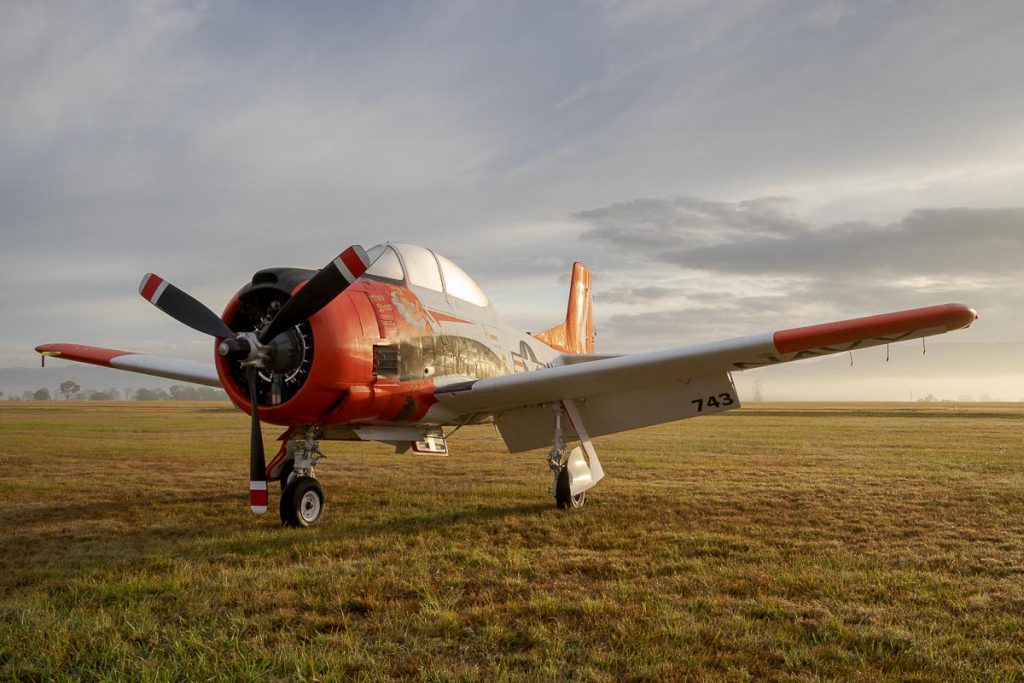 North American T-28B Trojan VH-RPX "Miss Stress" in a foggy sunrise at Red Thunder 2018 airshow.