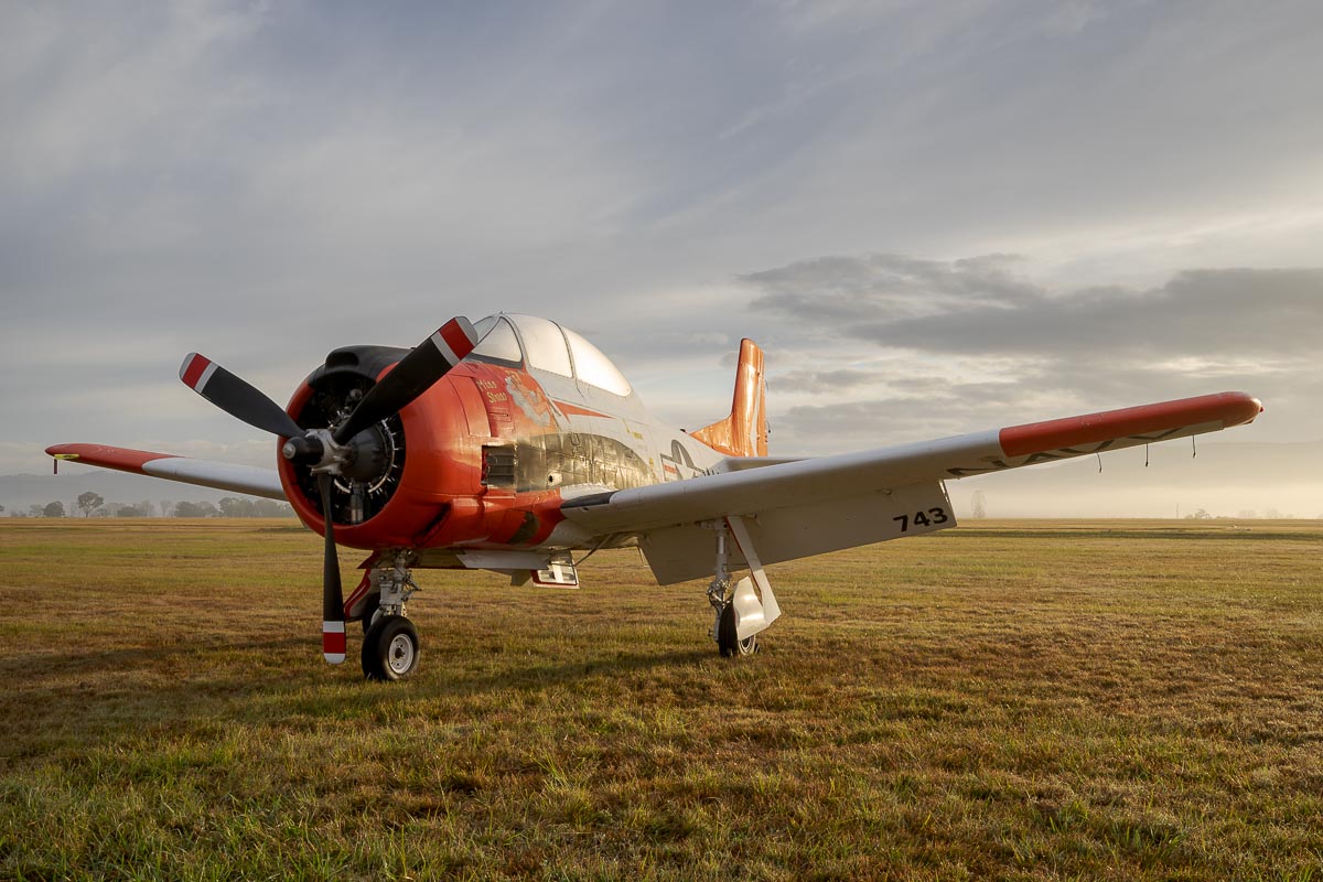 North American T-28B Trojan VH-RPX "Miss Stress" in a foggy sunrise at Red Thunder 2018 airshow.