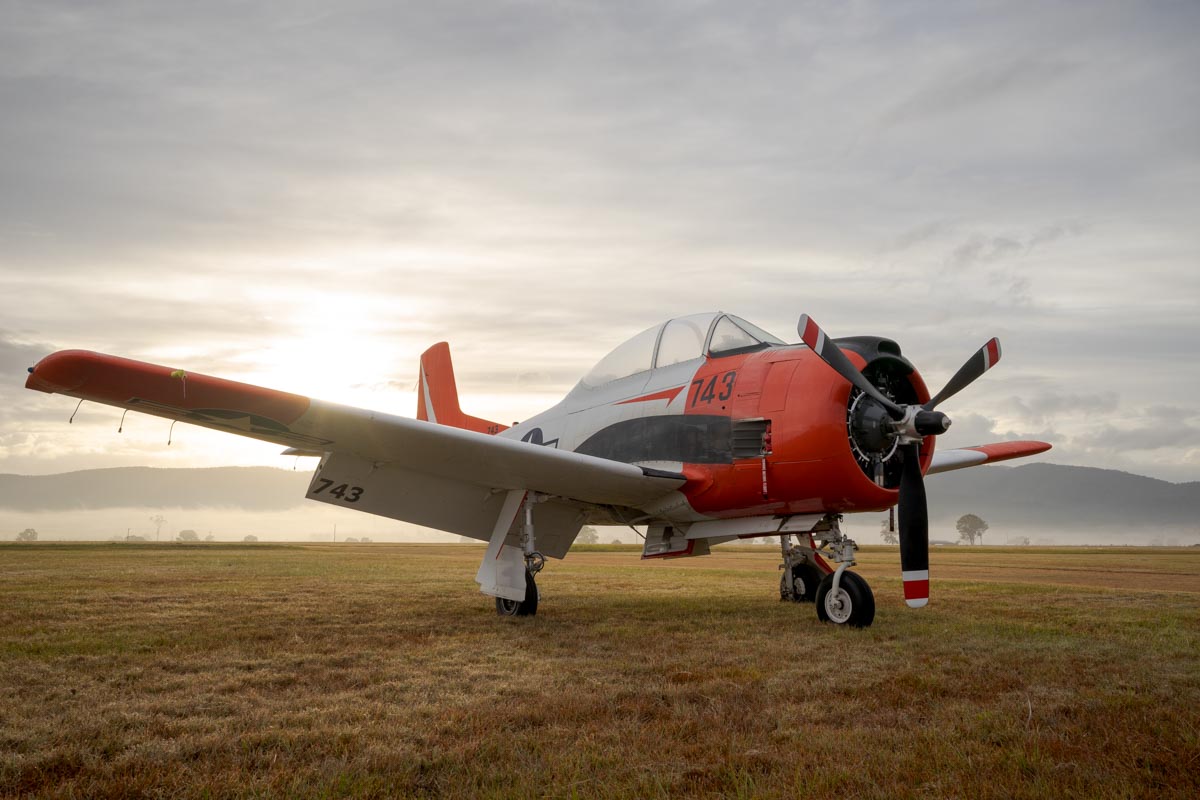 North American T-28B Trojan VH-RPX "Miss Stress" in a foggy sunrise at Red Thunder 2018 airshow.