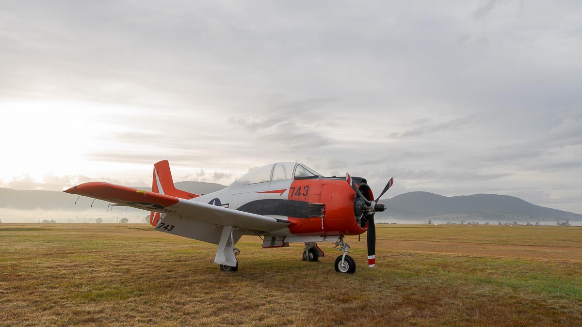 North American T-28B Trojan VH-RPX "Miss Stress" in a foggy sunrise at Red Thunder 2018 airshow.
