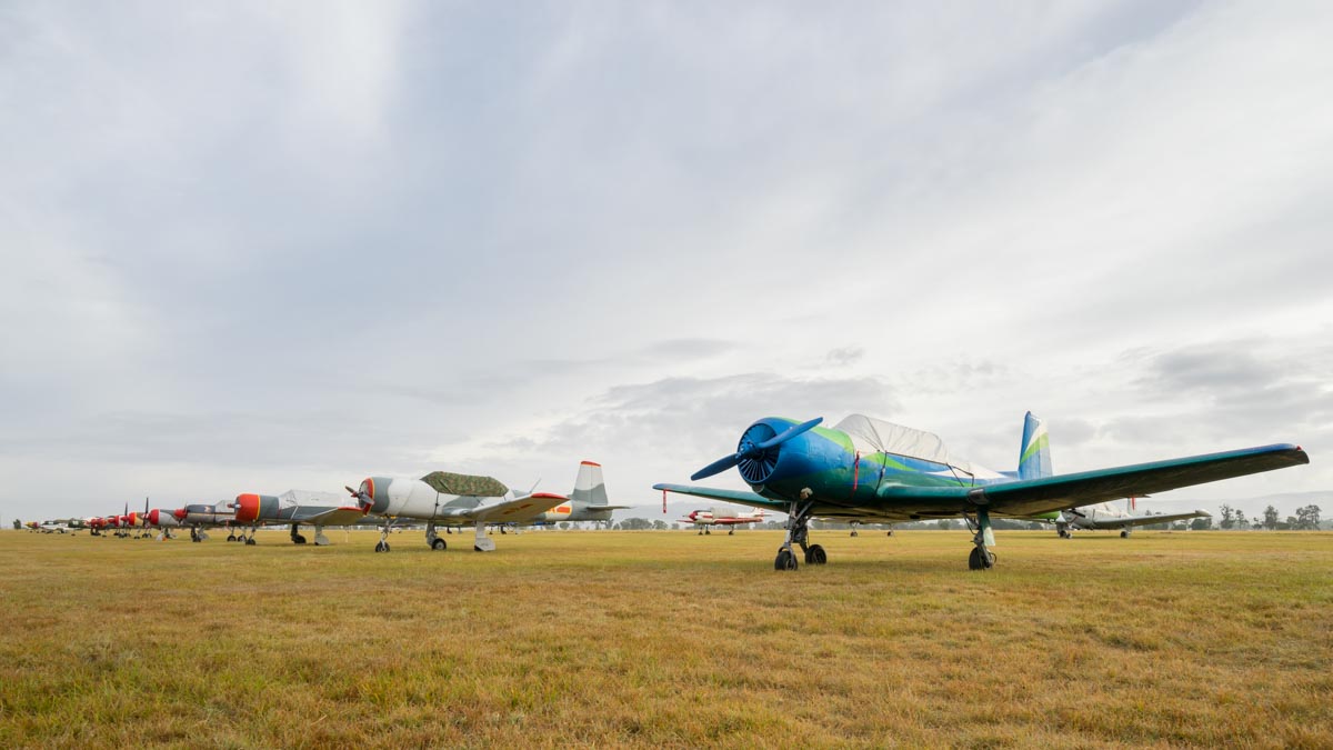 Nanchang CJ-6A and Yakovlev Yak-52 aircraft parked on the flight line at Red Thunder 2018 airshow.