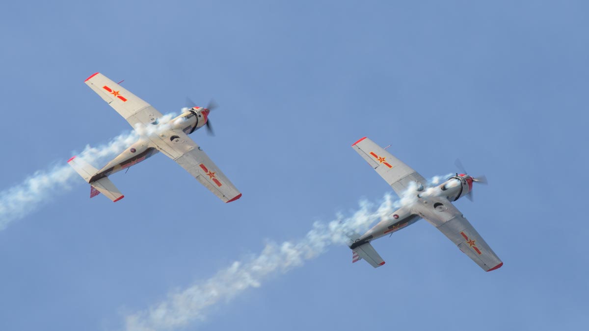 Nanchang CJ-6A VH-CJX "China Doll" and VH-NNG "Madam Chang" performing an aerobatic display.