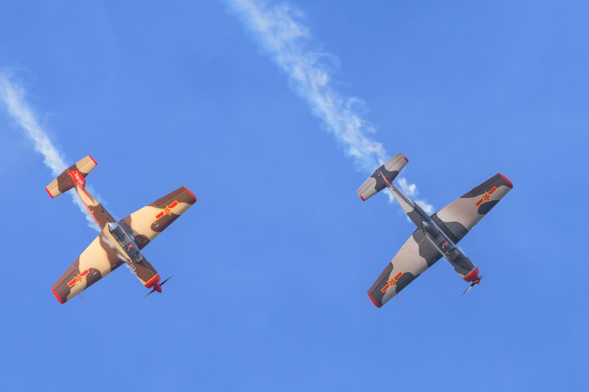 Nanchang CJ-6A VH-CJX "China Doll" and VH-NNG "Madam Chang" performing an aerobatic display.