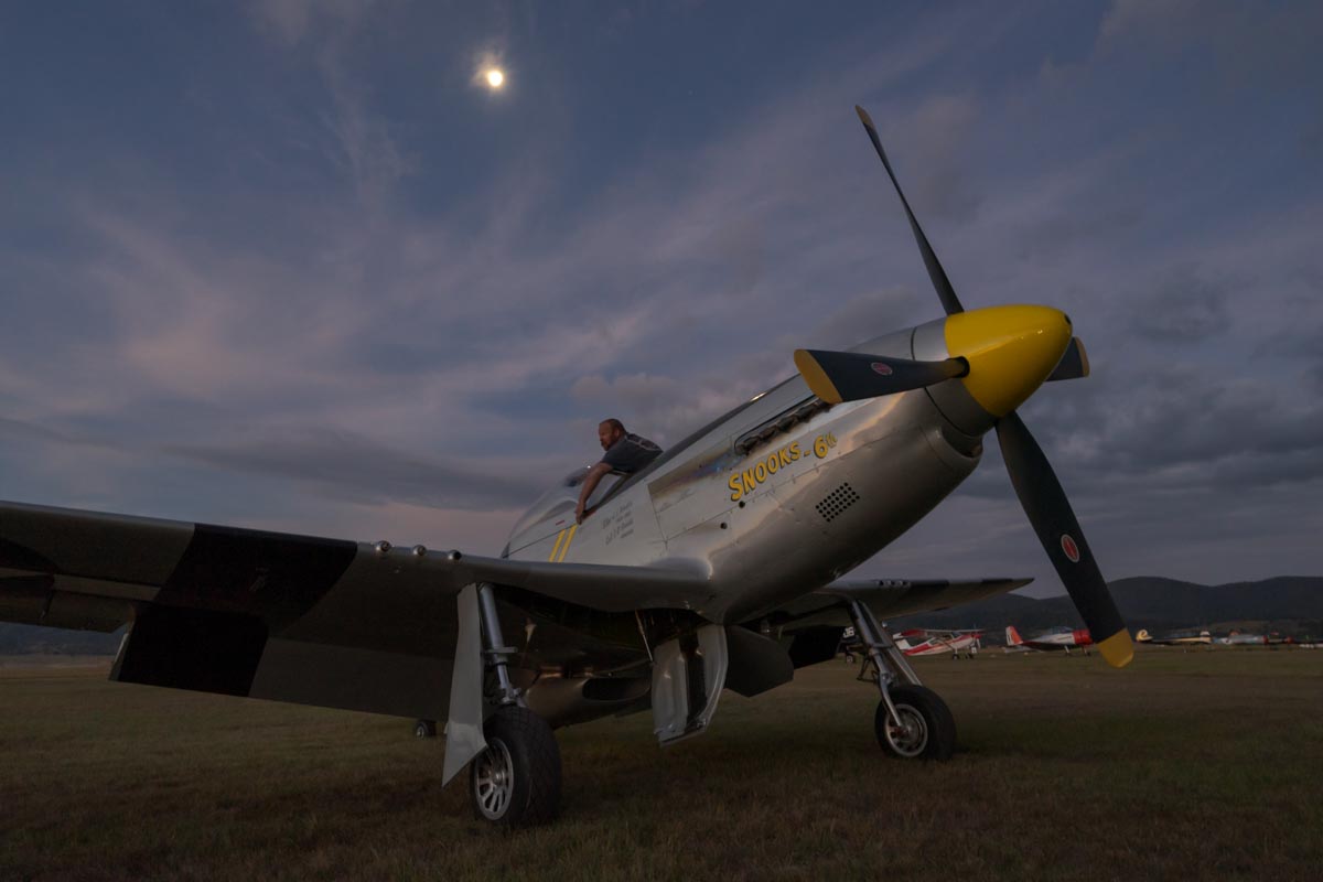 North American P-51D VH-FST "The Flying Undertaker/Snooks 6th" being put to bed with the moon rising overhead.