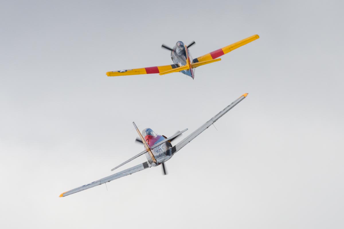 North American T-28D Trojans VH-ZUC and VH-ZUK forming up in line astern after a pass over the airfield.