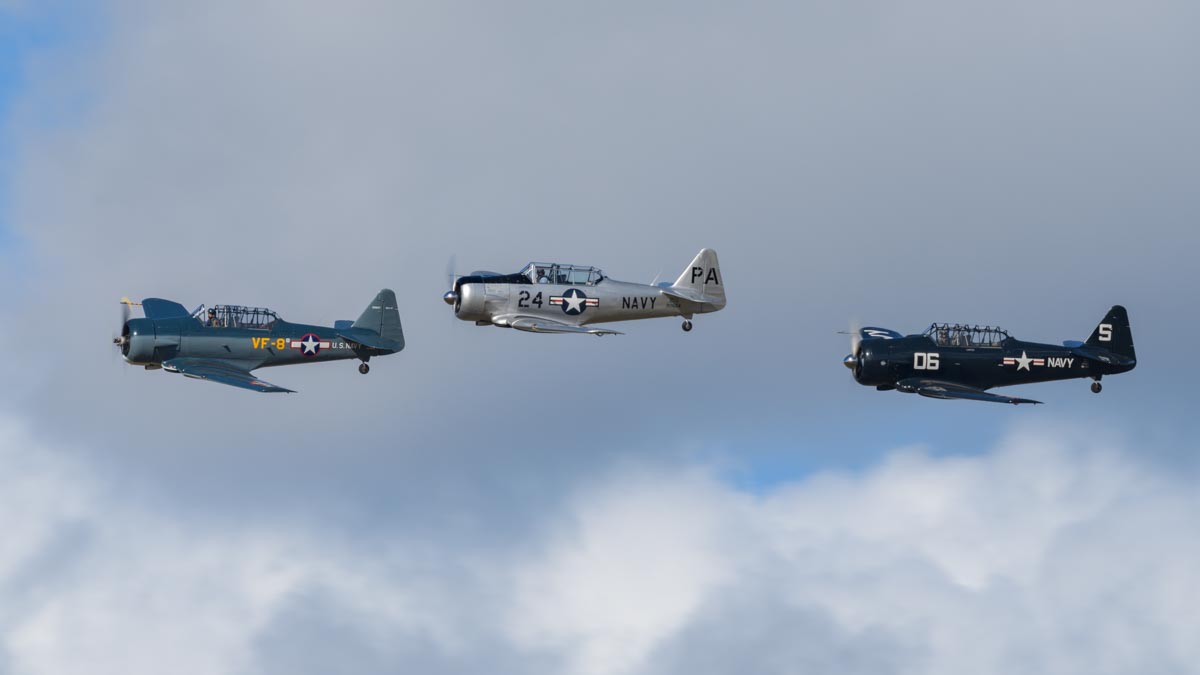 North American Texans VH-NAG (SNJ-4), VH-USN (SNJ-5) and VH-TEX (AT-6C) flying in formation at Red Thunder 2018 airshow.