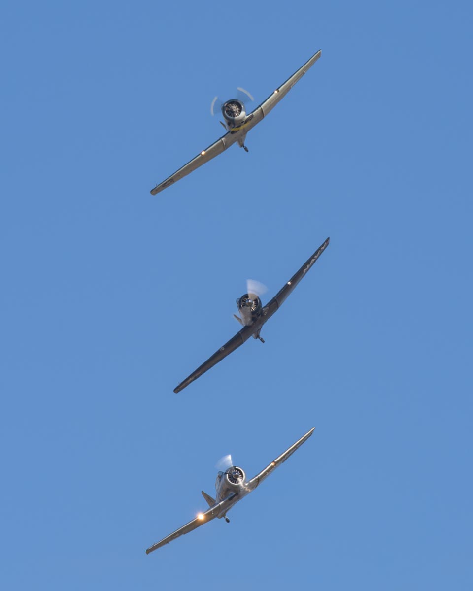 North American Texans VH-NAG (SNJ-4), VH-USN (SNJ-5) and VH-TEX (AT-6C) flying in formation at Red Thunder 2018 airshow.