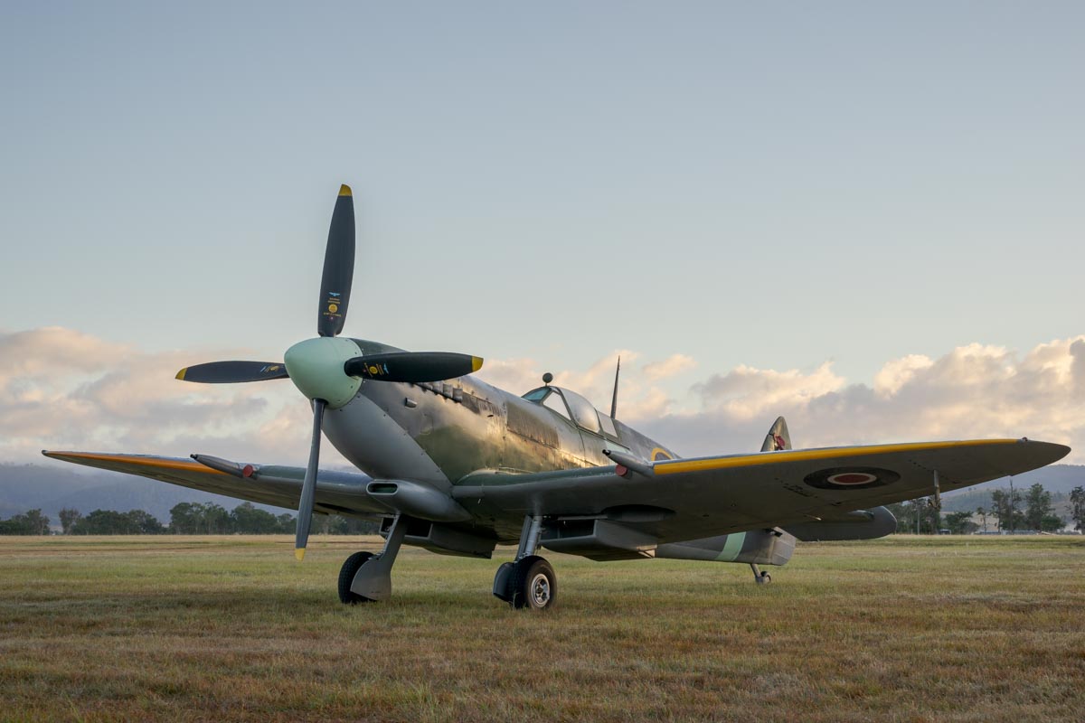 Temora Aviation Museum Supermarine Spitfire Mk XVI VH-XVI parked on the airfield on a foggy morning in golden hour at Red Thunder Airshow 2018.