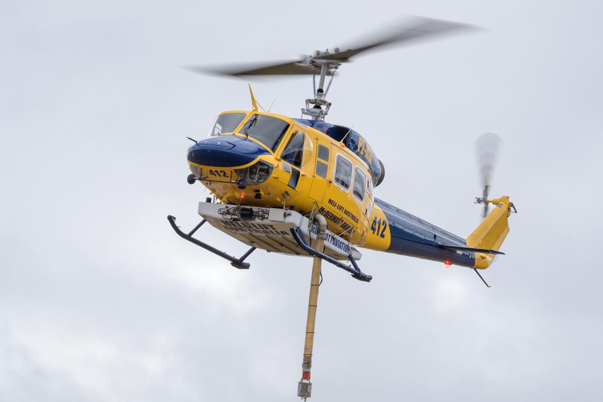 Bell 214B-1 P2-MSA operated by McDermott Aviation. It is configured as a water bomber, the suction hose is extended in this shot.
