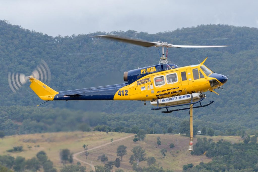 Bell 214B-1 P2-MSA operated by McDermott Aviation. It is configured as a water bomber, the suction hose is extended in this shot.
