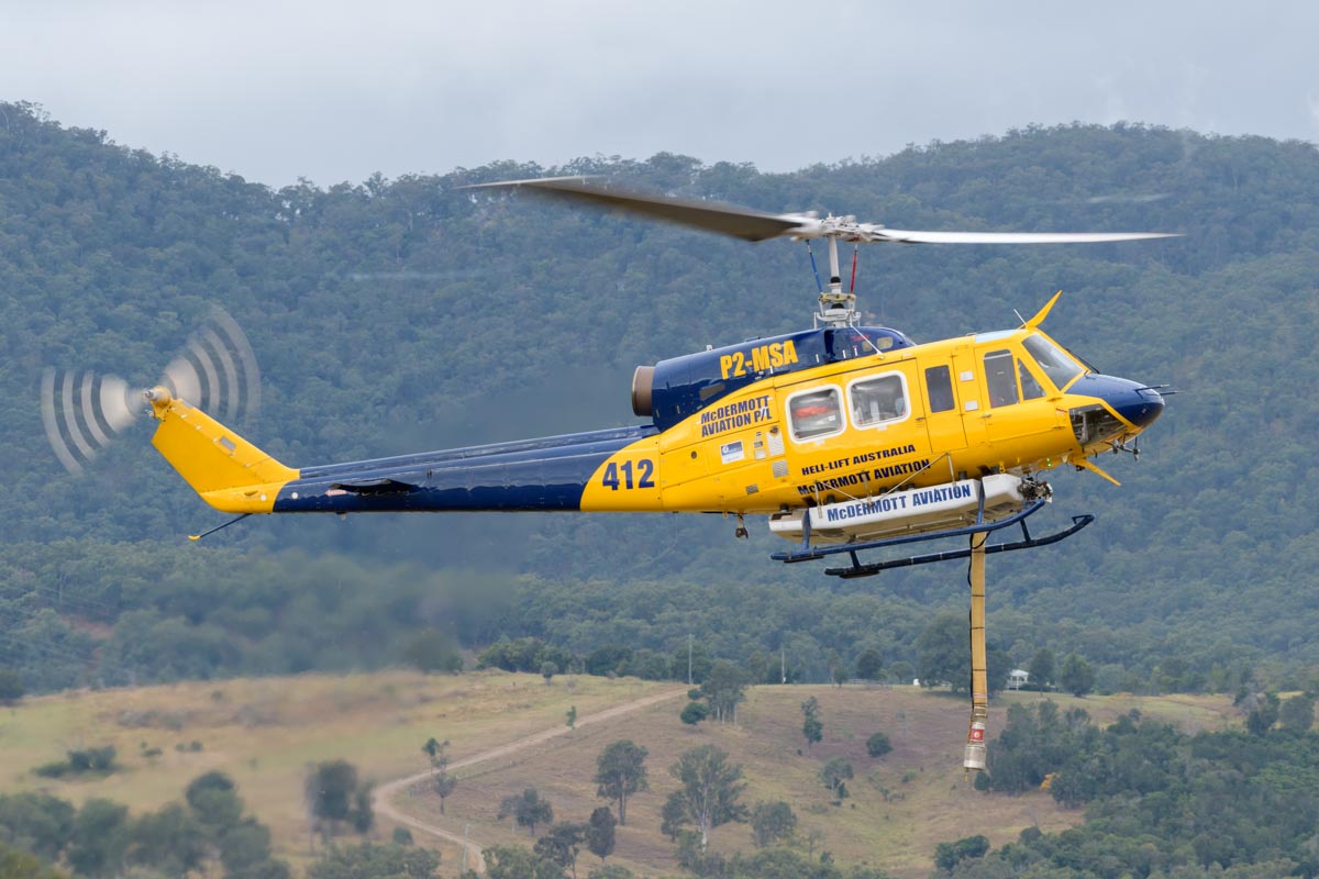 Bell 214B-1 P2-MSA operated by McDermott Aviation. It is configured as a water bomber, the suction hose is extended in this shot.