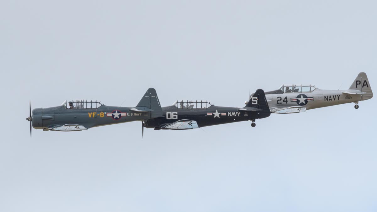 North American Texans VH-NAG (SNJ-4), VH-USN (SNJ-5) and VH-TEX (AT-6C) flying in formation.