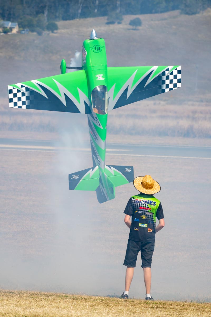 Aaron "Bones" Garle balances his RC model aircraft on its tail at Lismore Aviation Expo 2018 airshow.