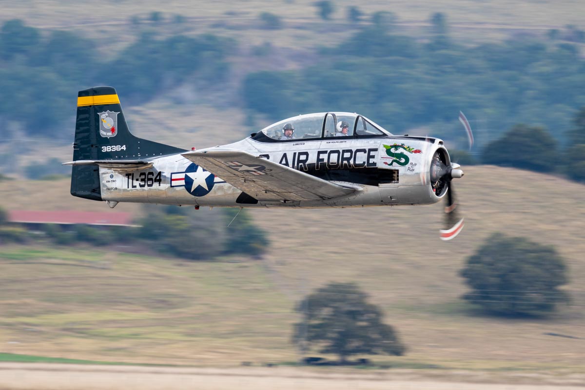 North American T-28D Trojan VH-TRO "Huff n Puff" just after takeoff on an adventure flight at the Lismore Aviation Expo 2018 airshow.