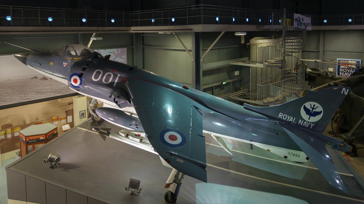 Hawker-Siddeley Sea Harrier FRS.1 XZ493 displayed as about to lift off from an aircraft carrier ski jump ramp at the Royal Navy Fleet Air Arm Museum.