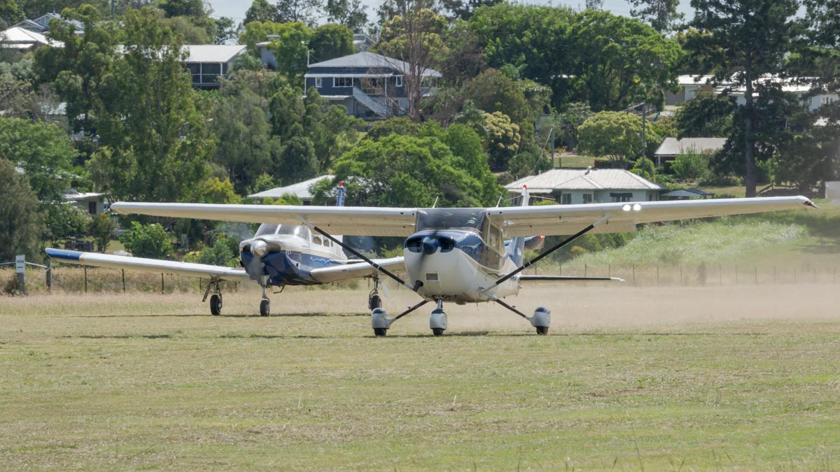 Piper PA-28R-200 Arrow II and Cessna 172 Skyhawk SP VH-WJO and VH-WPL taking off in formation at the Airsport Qld breakfast fly-in.