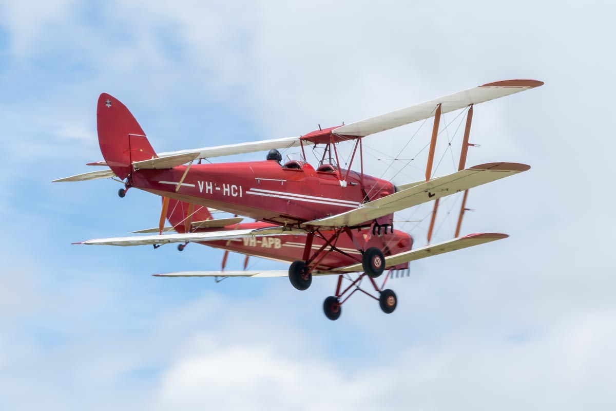 De Havilland DH.82A Tiger Moth VH-HCI and VH-APB taking off in formation at the Airsport Qld breakfast fly-in.