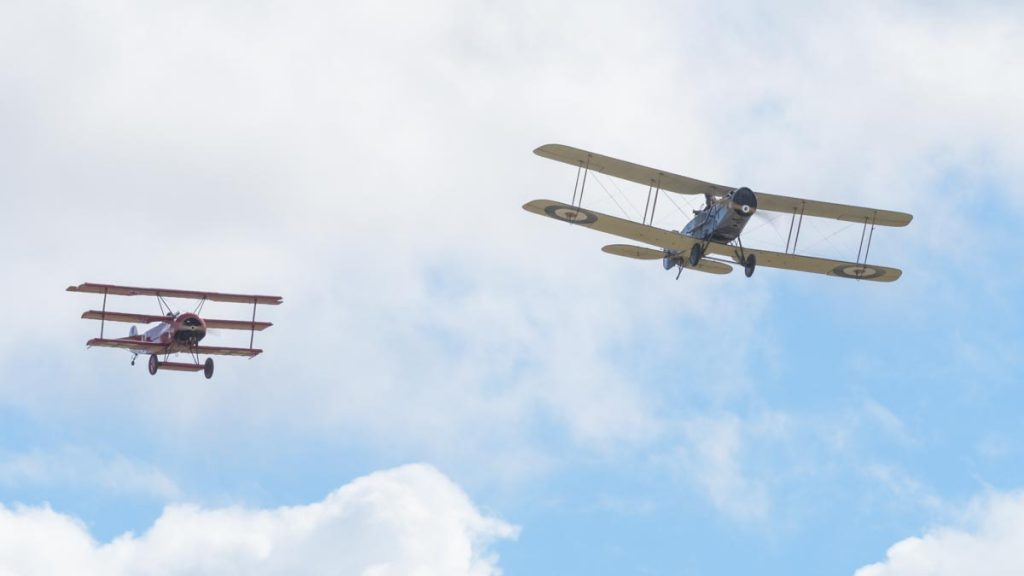 Fokker DR.I VH-FXP and Bristol F.2B VH-IIZ staging a mock dogfight to re-enact the shooting down of the Red Baron at Red Thunder 2018 airshow.